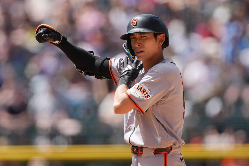 San Francisco Giants' Jung Hoo Lee gestures to the dugout after hitting a double off Colorado Rockies relief pitcher Zach Agnos in the fifth inning of a baseball game Sunday, May 31, 2026, in Denver. (AP Photo/David Zalubowski)