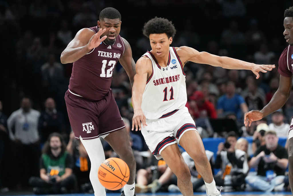 Saint Mary's guard Dillan Shaw (11) tries to beat Texas A&M forward Rashaun Agee (12) to the ball during the first half in the first round of the NCAA college basketball tournament, Thursday, March 19, 2026, in Oklahoma City. (AP Photo/Kyle Phillips)
