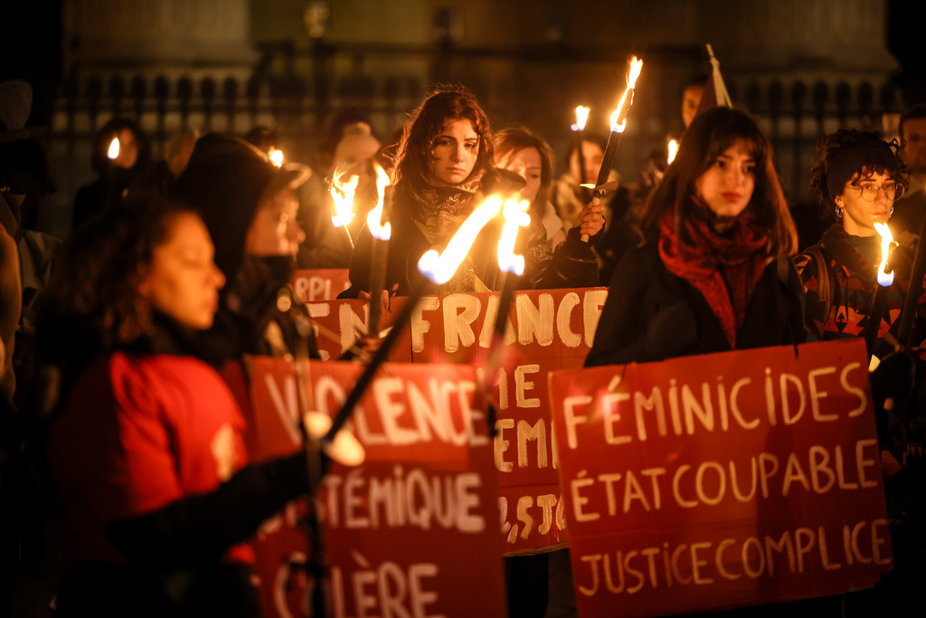 Women with torches and placards protest in front of the Pantheon to mark the international day for the elimination of violence against women, in Paris, France, Tuesday, Nov. 25. 2025. (AP Photo/Thomas Padilla)