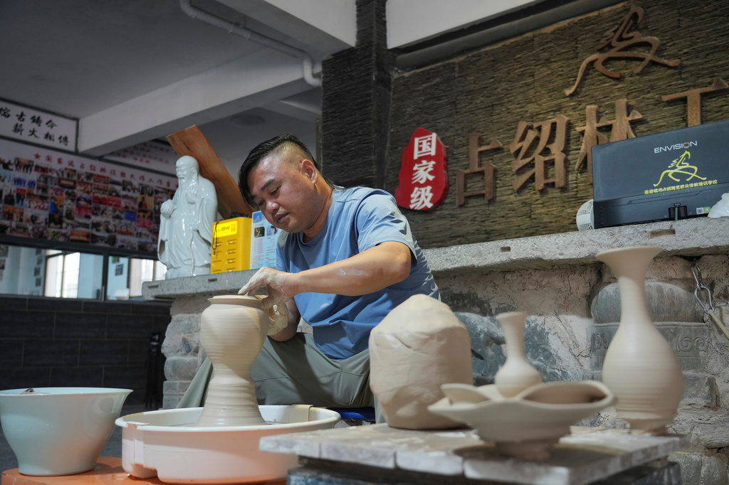 Chinese ceramic wheel-throwing artist Zhan Shaolin demonstrates his craft in Jingdezhen, known as China's "Porcelain Capital," in eastern China's Jiangxi province, Tuesday, Sept. 1, 2026. (AP Photo/Achmad Ibrahim)