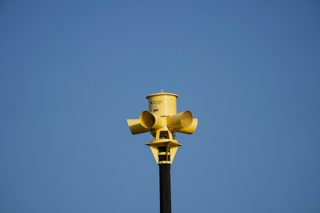 FILE - An emergency siren is visible on top of the Comfort Volunteer Fire Department in Comfort, Texas, July 10, 2025. (AP Photo/Ashley Landis, File)