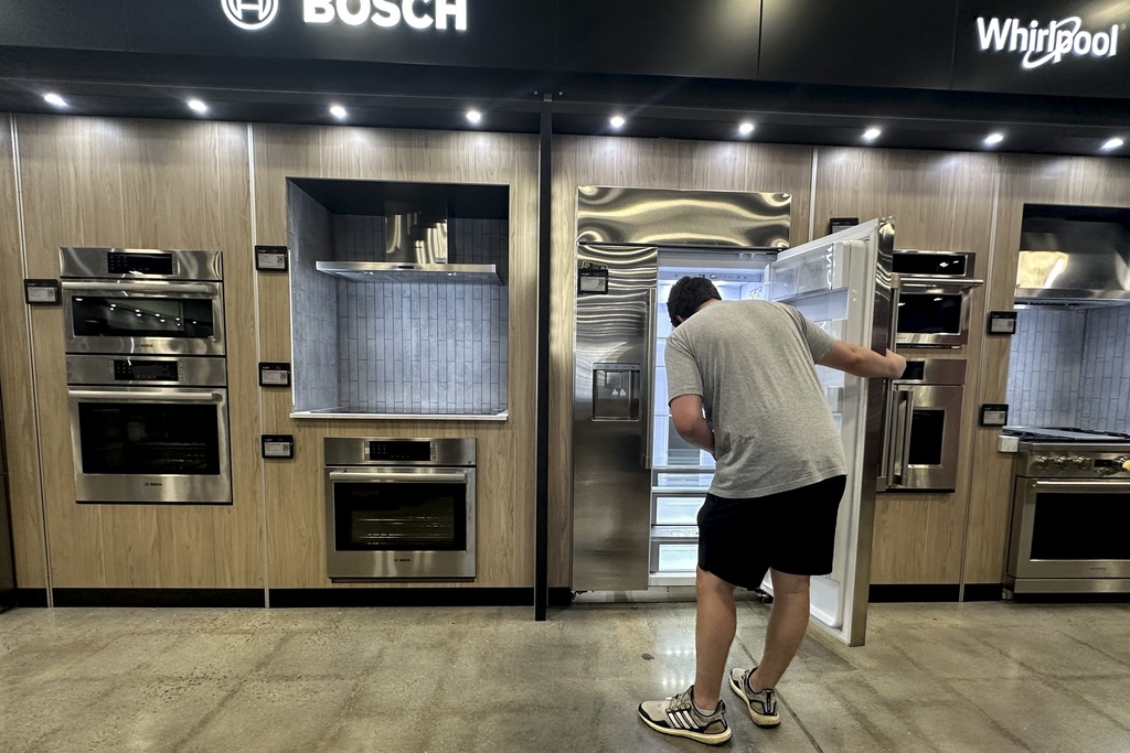 A man views a new appliance at a store in Kennesaw, Ga., on Thursday, Aug. 14, 2025. (AP Photo/Mike Stewart)