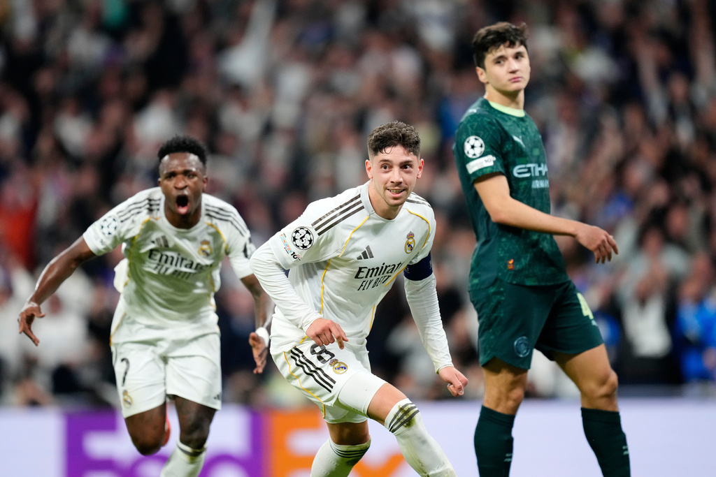 Real Madrid's Federico Valverde, center, celebrates after scoring during a first leg round of 16 Champions League soccer match between Real Madrid and Manchester City in Madrid, Spain, Wednesday, March 11, 2026. (AP Photo/Jose Breton)
