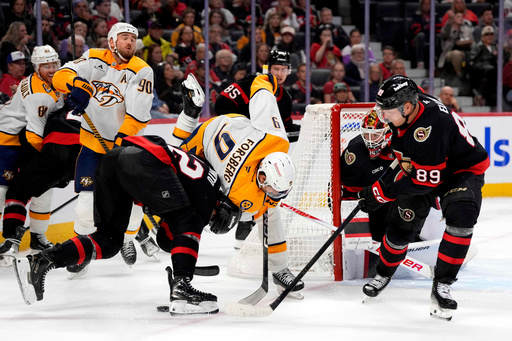 Nashville Predators' Filip Forsberg (9) and Ottawa Senators' Thomas Chabot (72) battle for the puck in front of goaltender Linus Ullmark (35) and Lars Eller (89) during first period NHL hockey action in Ottawa, Monday, Oct. 13, 2025. (Justin Tang/The Canadian Press via AP) Nashville Predators' Filip Forsberg (9) and Ottawa Senators' Thomas Chabot (72) battle for the puck in front of goaltender Linus Ullmark (35) and Lars Eller (89) during first period NHL hockey action in Ottawa, Monday, Oct. 13, 2025. (Justin Tang/The Canadian Press via AP)
