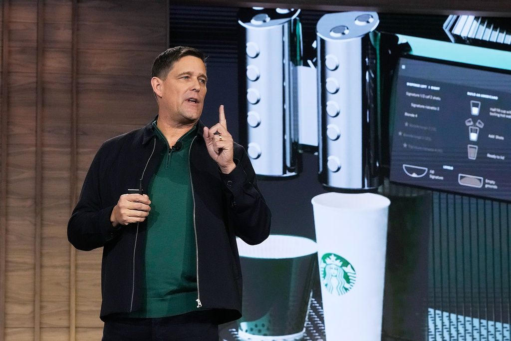 Executive Vice President and Chief Operating Officer Mike Grams speaks during the Starbucks Investor Day event, with an image of the company's Mastrena 3 espresso machine, in New York, Thursday, Jan. 29, 2026. (AP Photo/Richard Drew)