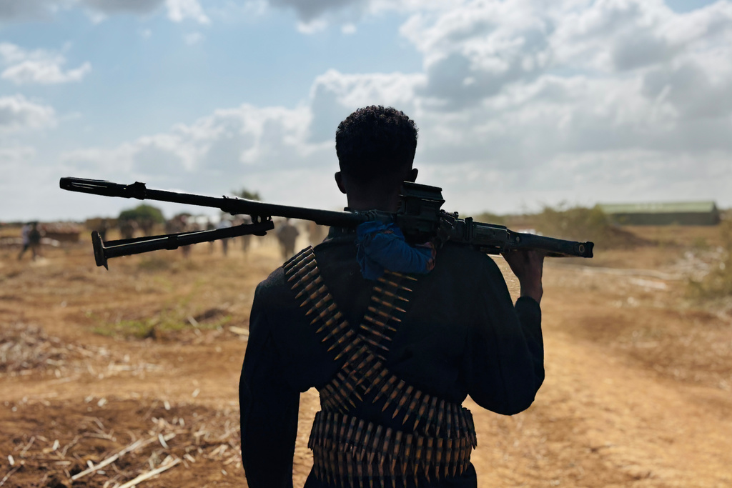 FILE - A Somalia National Army (SNA) soldier with ammunition belts strapped around him stands on the frontline in Sabiid Canole, Somalia, Nov. 11, 2025. (AP Photo/Jackson Njehia, file)