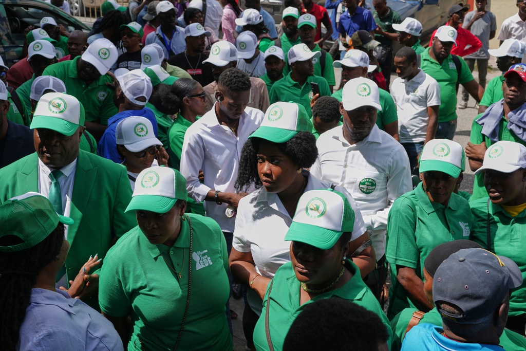 Members of the EDE (Committed to Development) political party arrive to register the party at the Provisional Electoral Council in the Petion-Ville neighborhood of Port-au-Prince, Haiti, Thursday, March 12, 2026. (AP Photo/Odelyn Joseph)