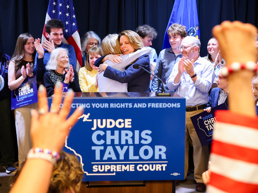 Wisconsin State Supreme Court Justice-elect Chris Taylor, right, hugs state Supreme Court Chief Justice Jill J. Karofsky on Tuesday, April 7, 2026, in Madison, Wis. (Owen Ziliak/Wisconsin State Journal via AP)