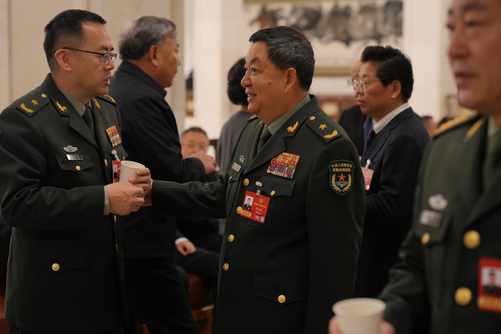 Military delegates chat before the opening session of the National People's Congress (NPC) in Beijing, Thursday, March 5, 2026. (AP Photo/Andy Wong)