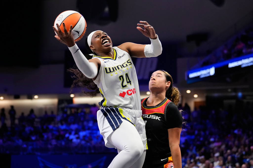 Dallas Wings guard Arike Ogunbowale (24) shoots over Connecticut Sun's Charlisse Leger-Walker, right, defends in the first half of a WNBA basketball game Sunday, Aug. 30, 2026, in Arlington, Texas. (AP Photo/Tony Gutierrez)