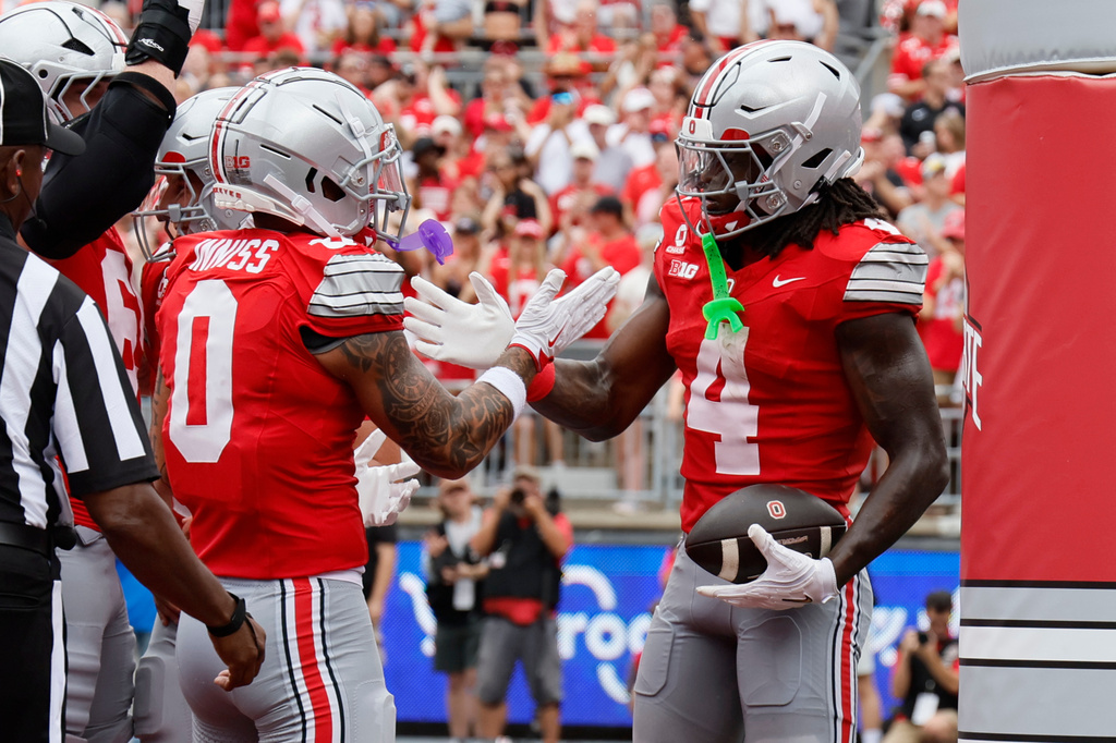 Ohio State wide receiver Jeremiah Smith, right, celebrates his touchdown reception against Ball State with teammate Brandon Inniss during the first half of an NCAA college football game, Saturday, Sept. 5, 2026, in Columbus, Ohio. (AP Photo/Jay LaPrete)