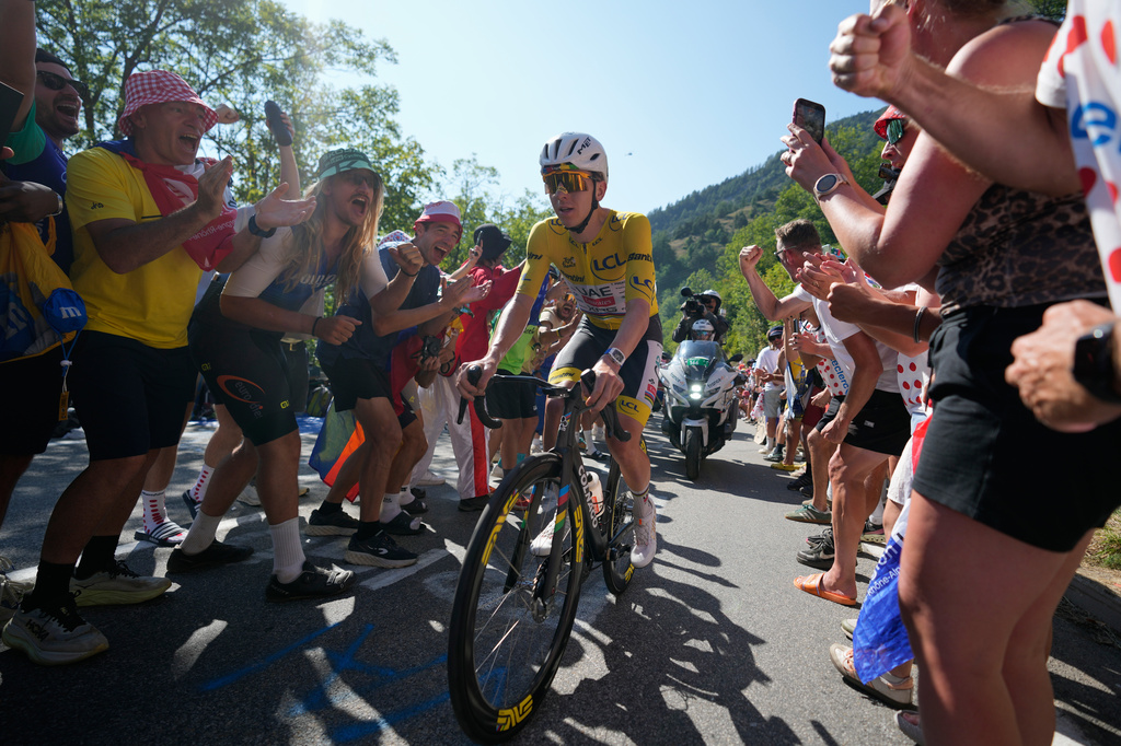 Slovenia's Tadej Pogacar, wearing the overall leader's yellow jersey, climbs Alpe d'Huez during the nineteenth stage of the Tour de France cycling race with start in Gap and finish in Alpe d'Huez, France, Friday, July 24, 2026. (AP Photo/Mosa'ab Elshamy)