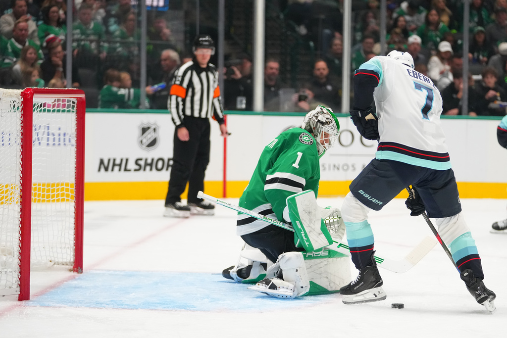 Seattle Kraken right wing Jordan Eberle (7) attacks against Dallas Stars goaltender Casey Desmith (1) during the second period of an NHL hockey game Sunday, Nov. 9, 2025, in Dallas. (AP Photo/Julio Cortez)