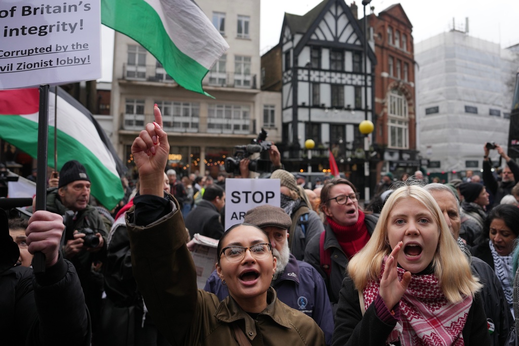 Supporters of Palestine Action stage a protest outside the Royal Court of Justice in London, Friday, Feb. 13, 2026. (AP Photo/Kin Cheung)