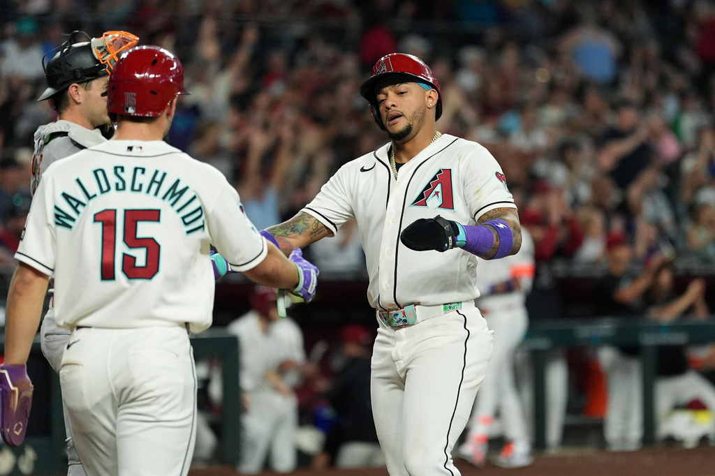 Arizona Diamondbacks' Ryan Waldschmidt (15) and Ketel Marte celebrate their runs scored against the San Francisco Giants during the fifth inning of a baseball game, Wednesday, May 20, 2026, in Phoenix. (AP Photo/Ross D. Franklin)