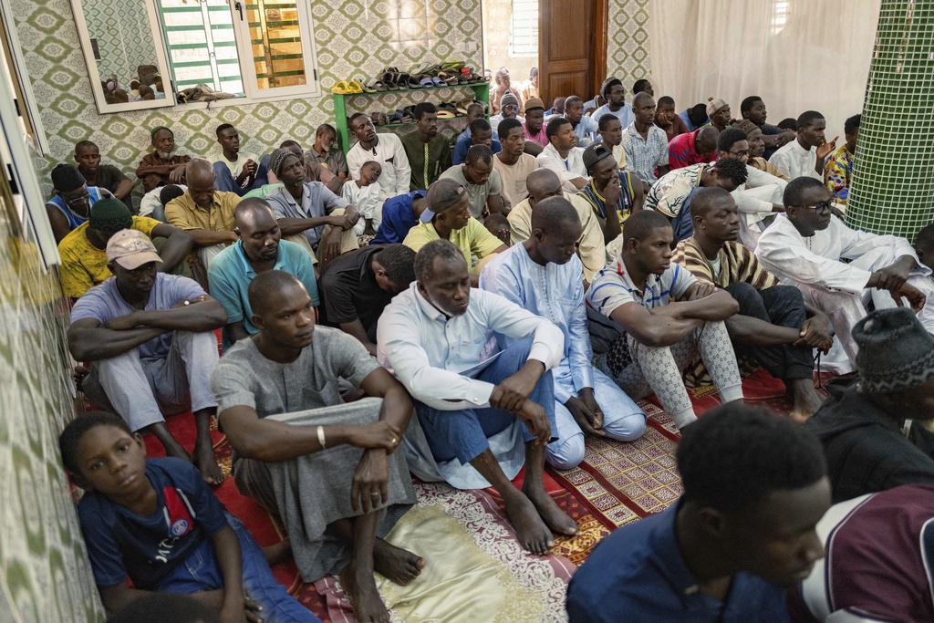 Worshippers listen to Imam Ibrahima Diane, advocate for an end to gender-based violence and practices like female genital mutilation, deliver his sermon at the Great Mosque of Nietty Mbar in Thiaroye, a suburb of Dakar, Senegal, Friday, July 4, 2025.(AP Photo/Sylvain Cherkaoui)