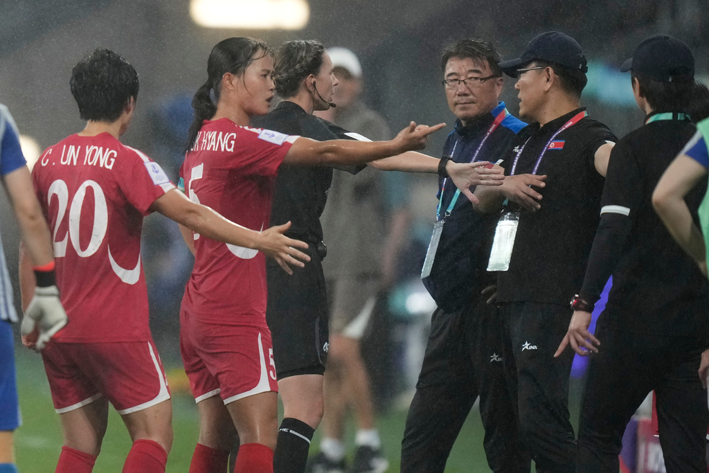 North Korean coaching staff argue with a match official after China's second goal during the Women's Asian Cup soccer match between China and North Korea in Sydney, Monday, March 9, 2026. (AP Photo/Rick Rycroft)
