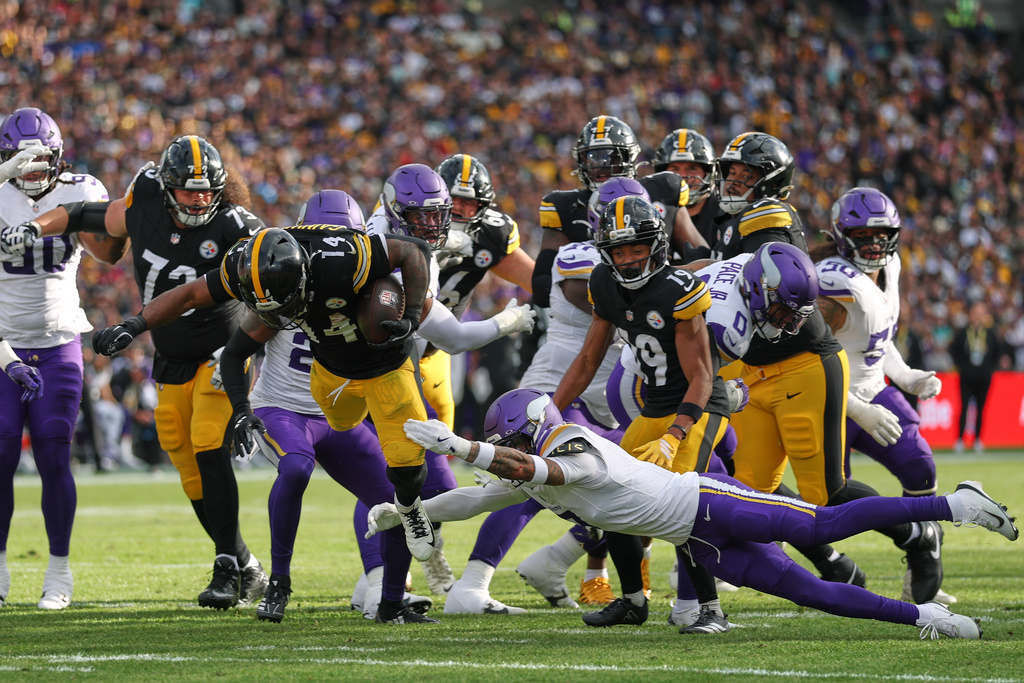 Pittsburgh Steelers running back Kenneth Gainwell (14) is tackled by Minnesota Vikings cornerback Byron Murphy (7) during the NFL football game between Minnesota Vikings and Pittsburgh Steelers at Croke Park stadium in Dublin, Sunday, Sept. 28, 2025.(AP Photo/Ian Walton)