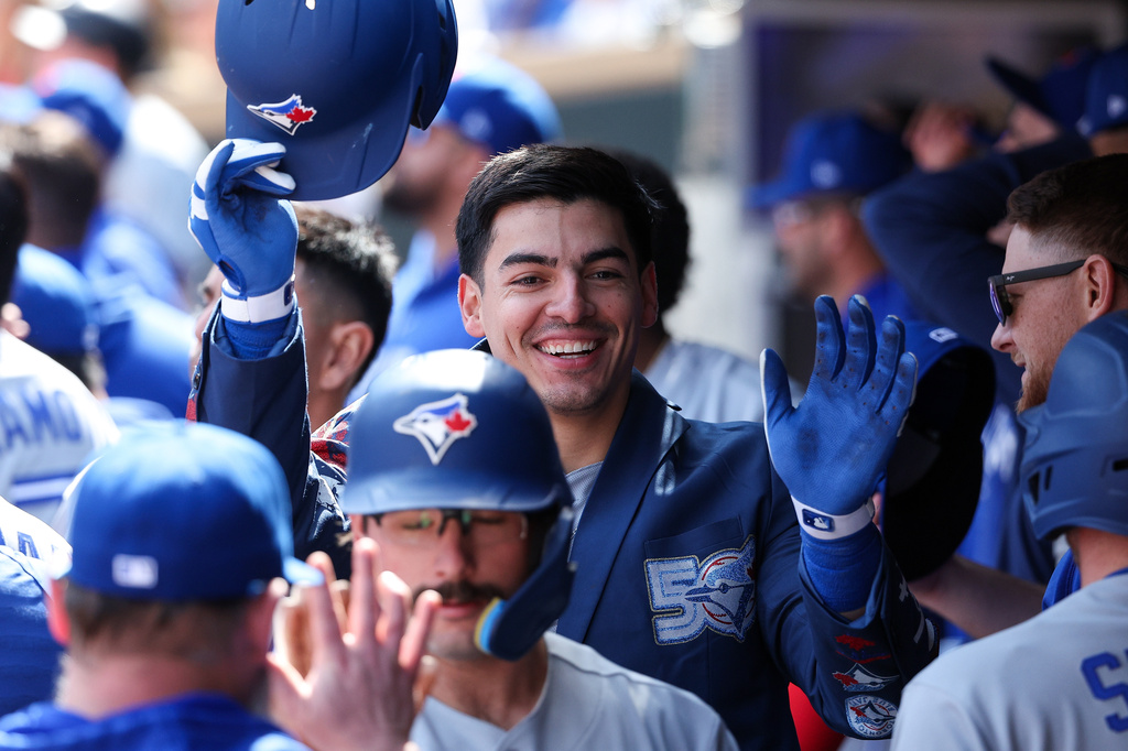 Toronto Blue Jays' Brandon Valenzuela, center, celebrates after his three-run home run against the Minnesota Twins during the eighth inning of a baseball game, Saturday, May 2, 2026, in Minneapolis. (AP Photo/Matt Krohn)