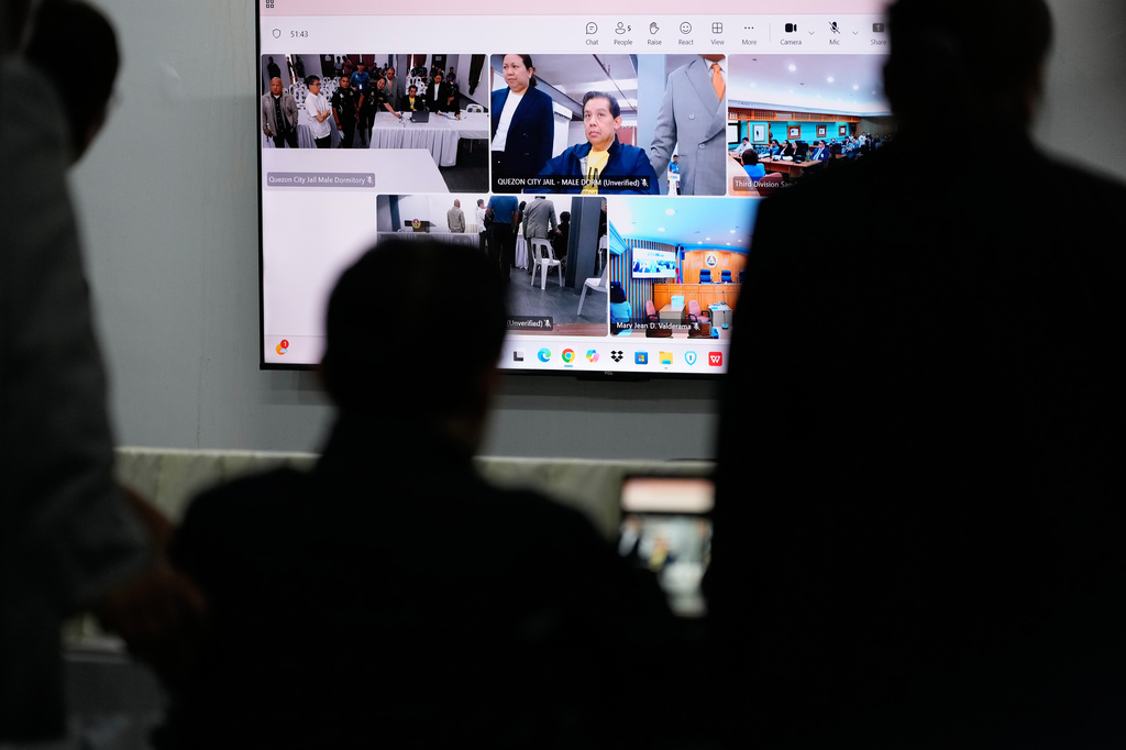 Philippines former House Speaker Martin Romualdez, center, a cousin of President Ferdinand Marcos Jr., watches the screen as he waits for the start of his arraignment via video conference at the Quezon City Jail in Quezon, Philippines, Wednesday, Sept. 16, 2026. (AP Photo/Aaron Favila, Pool)