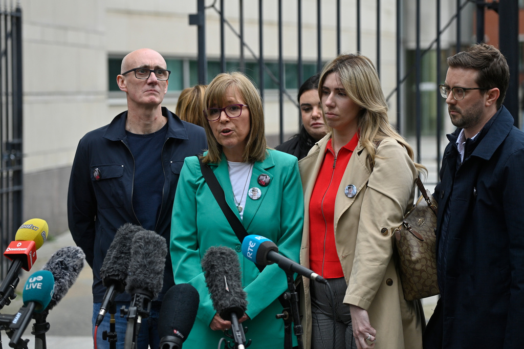 Lyra McKee's sister Nichola Corner, center, speaks to the media outside Belfast Crown Court in Belfast, Ireland, where Paul McIntyre, Peter Cavanagh and Jordan Gareth Devine have been found not guilty in a non-jury trial of the murder of journalist Lyra McKee, Friday July 3, 2026. (PA via AP)