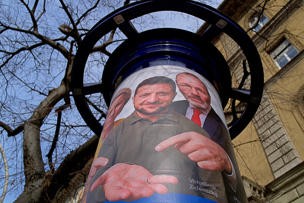 A billboard shows an AI-generated image of Ukrainian President Volodymyr Zelenskyy, center, flanked by European officials, in Budapest, Hungary, Monday, Feb. 23, 2026. (AP Photo/Bela Szandelszky)