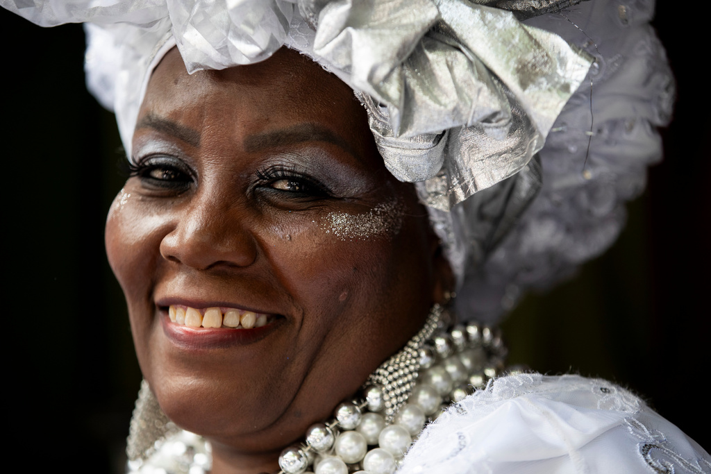 FILE - A woman smiles while waiting for the start of the Tia Ciata parade at the annual celebration marking Black Consciousness Day in Rio de Janeiro, Nov. 20, 2025. (AP Photo/Bruna Prado, File)