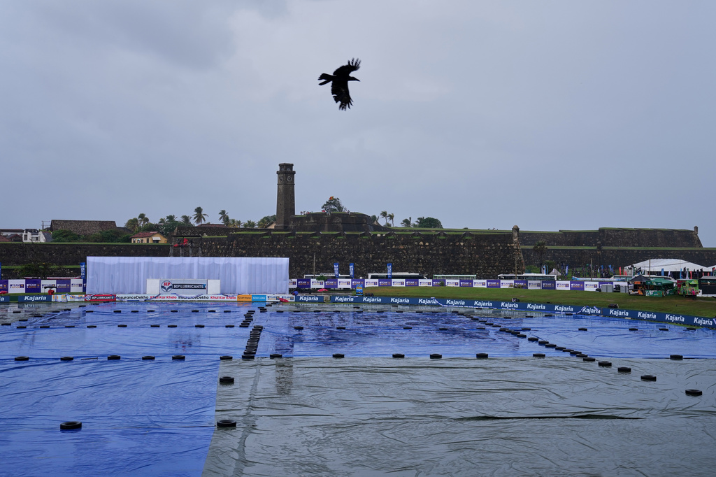 The outfield at the Galle international cricket stadium remains covered as rain falls during the two of the first test cricket match between Sri Lanka and India in Galle, Sri Lanka, Sunday, Aug. 16, 2026. (AP Photo/Eranga Jayawardena)