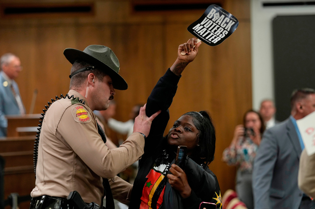 Jamiah Irby is removed by a state trooper from a Senate committee meeting during a special session of the state legislature to redraw U.S. Congressional voting maps Wednesday, May 6, 2026, in Nashville, Tenn. (AP Photo/George Walker IV)