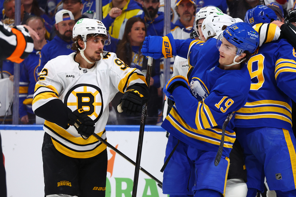 Boston Bruins center Marat Khusnutdinov (92) and Buffalo Sabres center Peyton Krebs (19) battle after a whistle during the first period in Game 1 of a first-round NHL hockey Stanley Cup playoff series Sunday, April 19, 2026, in Buffalo, N.Y. (AP Photo/Jeffrey T. Barnes)