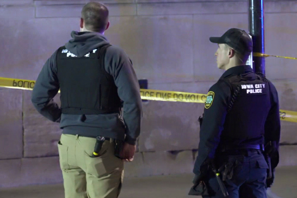 FILE - This image made from video provided by KCRG shows Iowa City police officers working the scene of a downtown shooting near the University of Iowa campus on Sunday, April 19, 2026. (KCRG via AP, File)