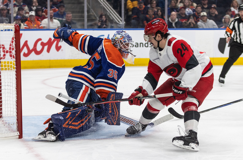 Carolina Hurricanes' Seth Jarvis (24) is stopped by Edmonton Oilers goalie Tristan Jarry (35) during the third period of an NHL game, in Edmonton on Friday, March 6, 2026. (Jason Franson/The Canadian Press via AP)