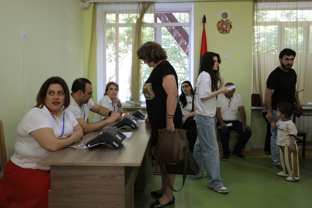 Voters gather to get their ballots at a polling station during the parliamentary election in Yerevan, Armenia, Sunday, June 7, 2026. (AP Photo/Anthony Pizzoferrato)