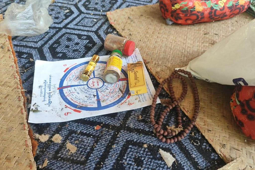 Personal belongings, including Buddhist prayer beads and medicine, are seen after an airstrike hit Swel Le Oh village in Myaung Township, Sagaing Region, Myanmar, on Friday, Aug. 21, 2026. (Ko Nway Oo via AP)