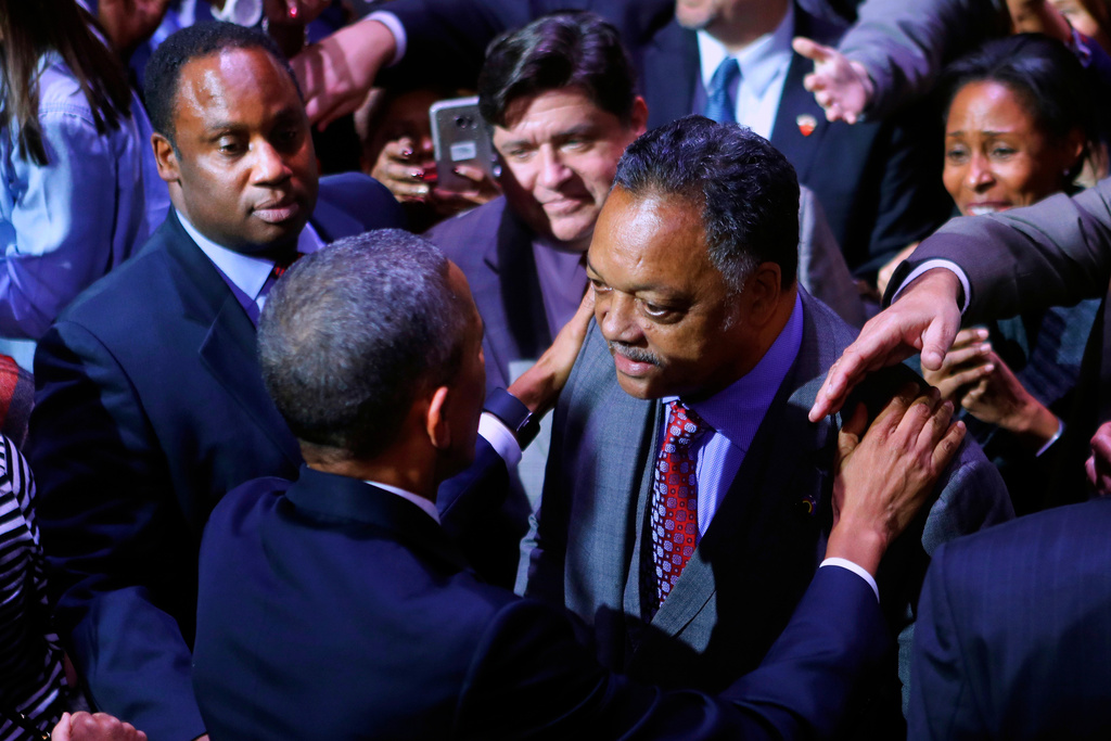 FILE - President Barack Obama talks with Rev. Jesse Jackson following his farewell address at McCormick Place in Chicago, Jan. 10, 2017. On the left is Jackson's son Jonathan Jackson. (AP Photo/Pablo Martinez Monsivais, File)