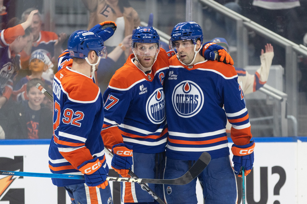 Edmonton Oilers' Vasily Podkolzin (92), Connor McDavid (97) and Evan Bouchard (2) celebrate after a goal against the Colorado Avalanche during second-period NHL hockey game action in Edmonton,Alberta, Monday, April 13, 2026. (Jason Franson/The Canadian Press via AP)