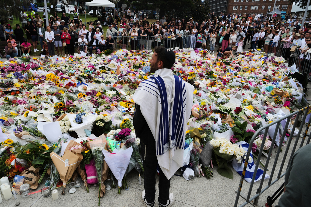 FILE - Rabbi Yossi Friedman speaks to people gathering at a flower memorial by the Bondi Pavilion at Bondi Beach on Tuesday, Dec. 16, 2025, following Sunday's shooting in Sydney, Australia. (AP Photo/Mark Baker, File)