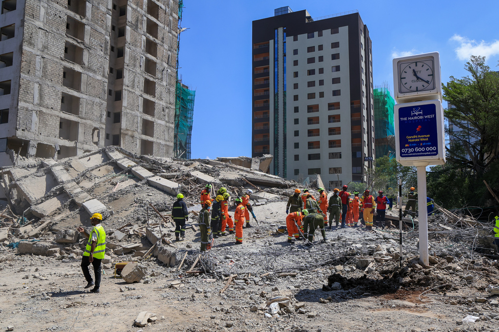 A rescue team works at the scene of a collapsed building in Nairobi, Kenya, Friday, Jan. 2, 2026. (AP Photo/Andrew Kasuku)