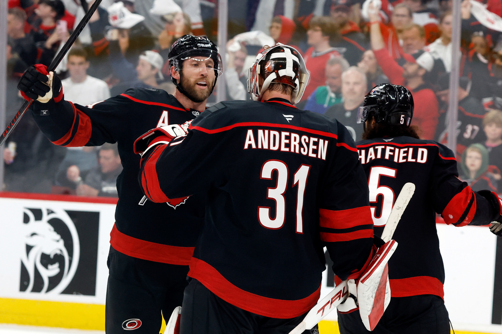 Carolina Hurricanes goaltender Frederik Andersen (31) is congratulated by Jaccob Slavin, left, following Game 1 of an NHL hockey Stanley Cup second-round playoff series against the Philadelphia Flyers in Raleigh, N.C., Saturday, May 2, 2026. (AP Photo/Karl DeBlaker)