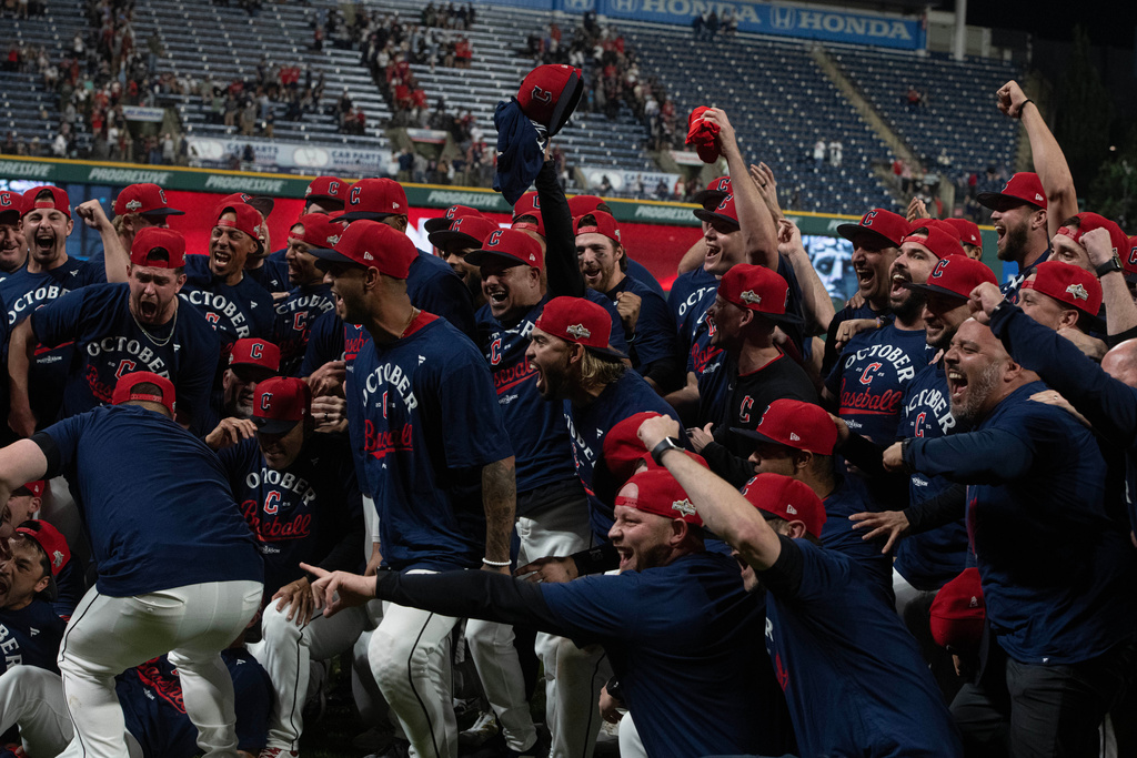 The Cleveland Guardians celebrate securing an American League playoff spot at the end of a baseball game, Saturday, Sept. 27, 2025, in Cleveland. (AP Photo/Phil Long)