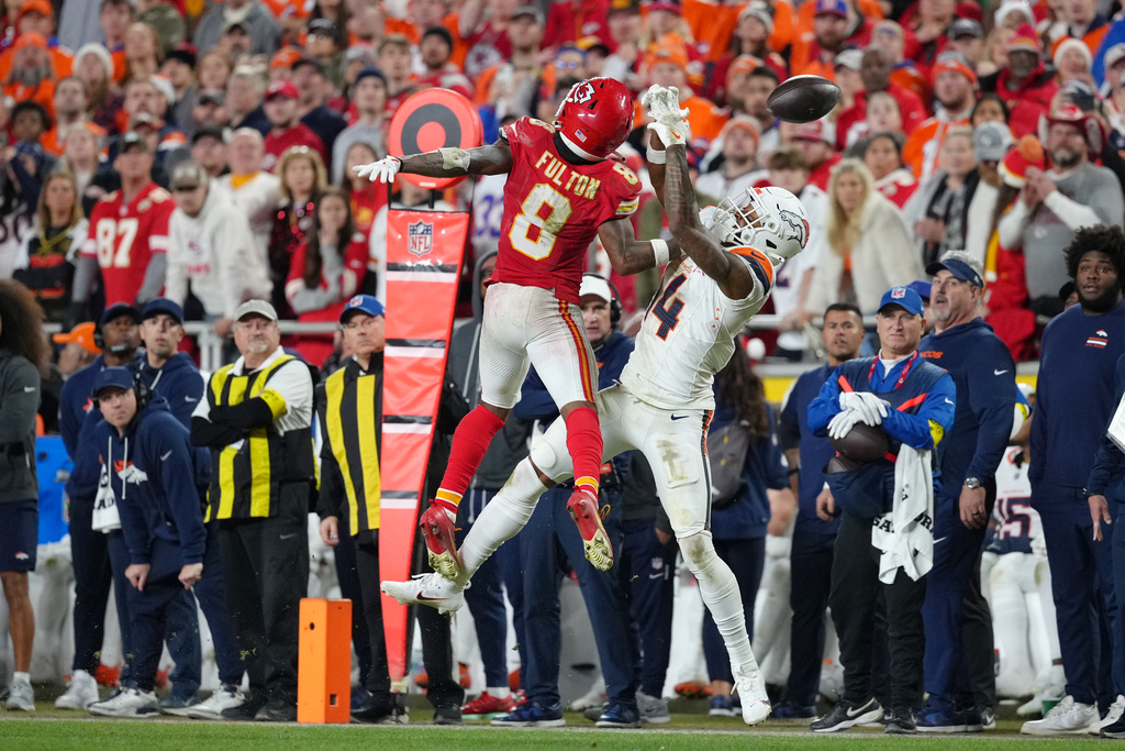 Kansas City Chiefs cornerback Kristian Fulton (8) breaks up a pass intended for Denver Broncos wide receiver Courtland Sutton (14) during the second half of an NFL football game Thursday, Dec. 25, 2025, in Kansas City. (AP Photo/Ed Zurga)