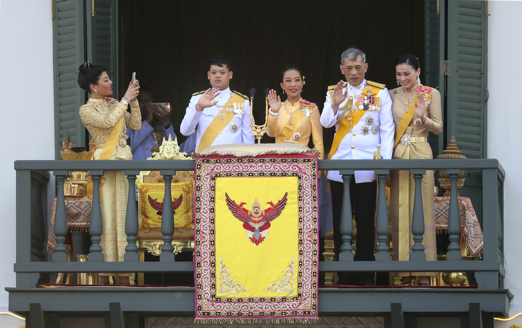 FILE - Princess Sirivannavari Nariratana, left, daughter of King Maha Vajiralongkorn, second right, and Queen Suthida, right, takes a photo of her royal family members also including Prince Dipangkorn Rasmijoti, second left, and Princess Bajrakitiyabha, as they wave towards audience members from the balcony of Suddhaisavarya Prasad Hall in the Grand Palace during the coronation ceremony, May 6, 2019, in Bangkok, Thailand. (AP Photo/Sakchai Lalit, File)