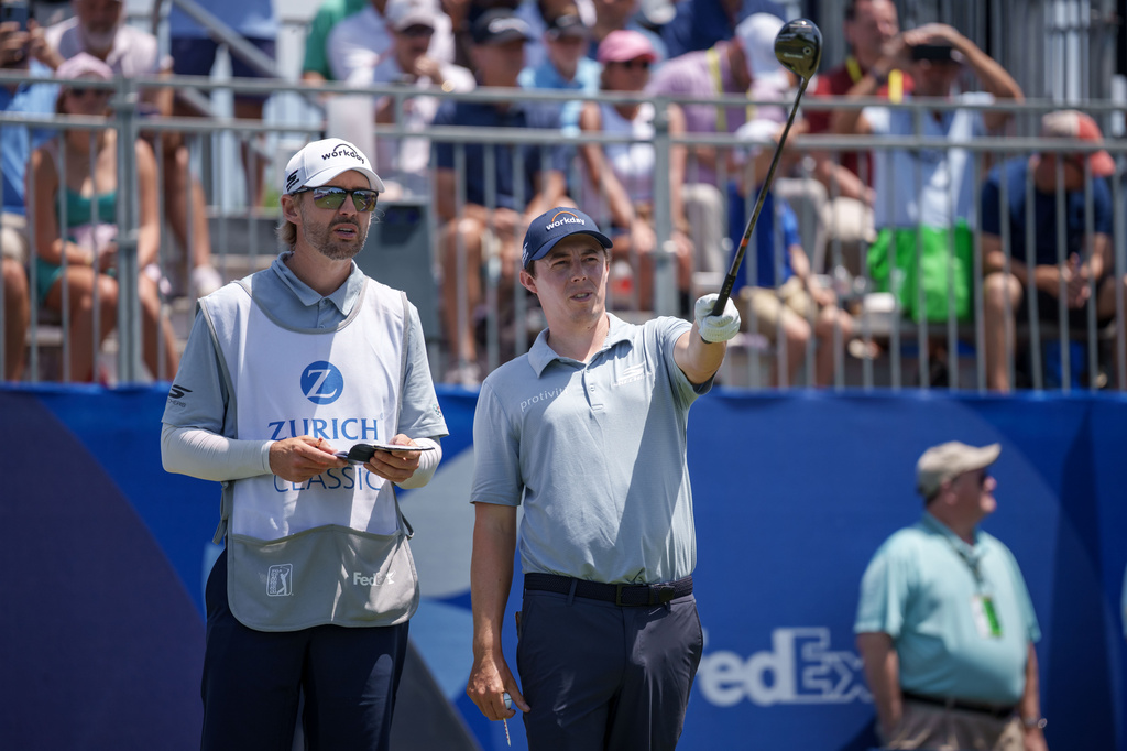 Matt Fitzpatrick, of England, talks with his caddie before teeing off on the first hole during the first round of the PGA Zurich Classic golf tournament, Thursday, April 23, 2026, in Avondale, La. (AP Photo/Matthew Hinton)