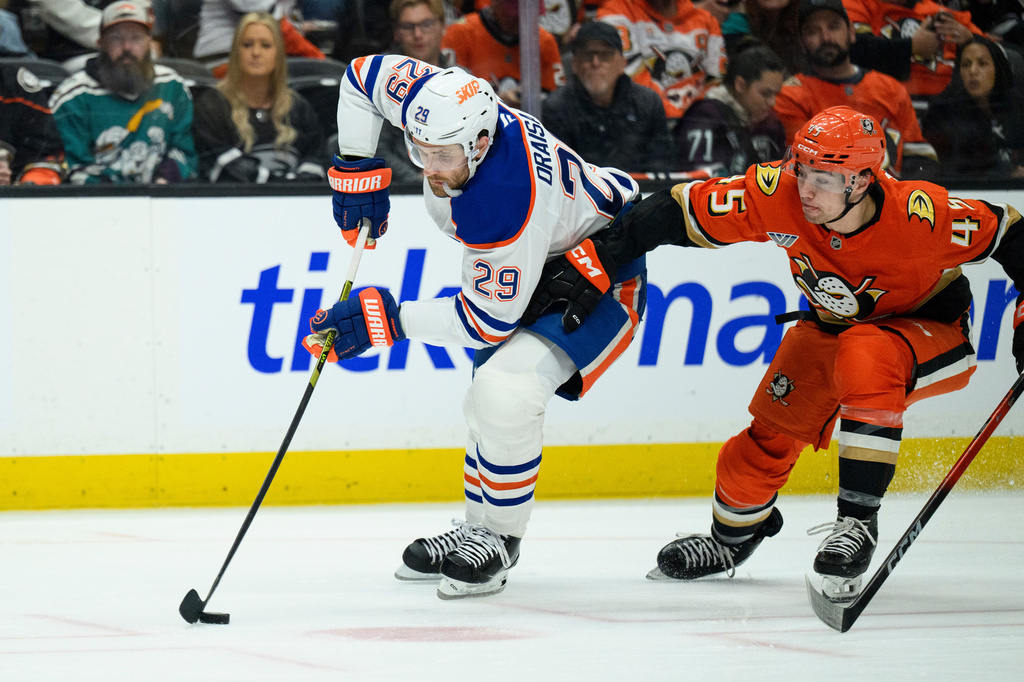 FILE - Edmonton Oilers center Leon Draisaitl, left, controls the puck as Anaheim Ducks right wing Beckett Sennecke defends during the second period of Game 4 in the first round of an NHL hockey Stanley Cup playoff series Sunday, April 26, 2026, in Anaheim, Calif. (AP Photo/Kyusung Gong), File)