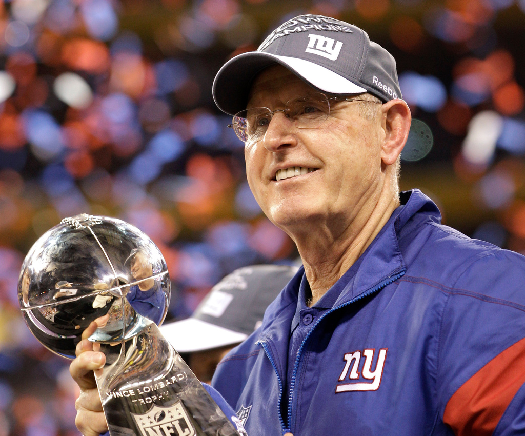 FILE - New York Giants head coach Tom Coughlin holds the Vince Lombardi Trophy after his team's 21-17 win over the New England Patriots in the NFL Super Bowl XLVI football game, Feb. 5, 2012, in Indianapolis. (AP Photo/David J. Phillip, File)