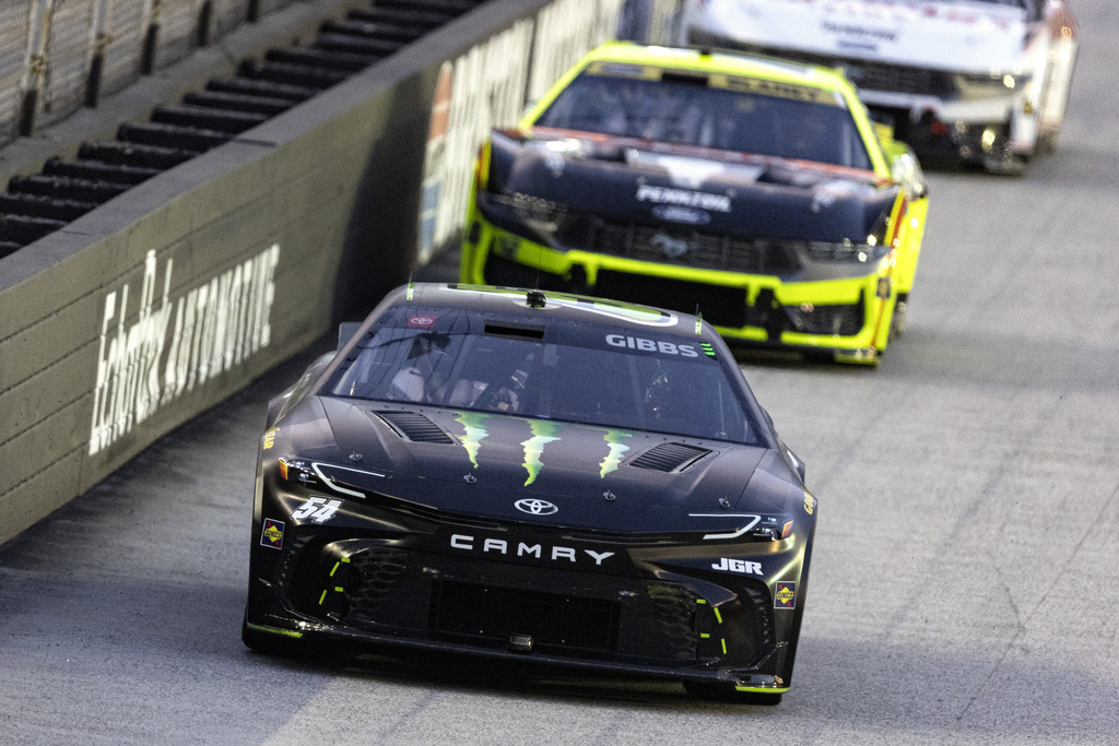Ty Gibbs (54) leads Ryan Blaney (12) during a NASCAR Cup Series auto race, Saturday, Sept. 13, 2025, in Bristol, Tenn. (AP Photo/Wade Payne)