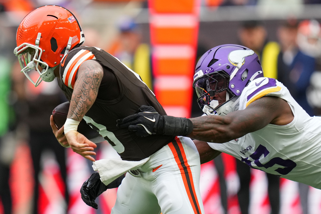 Cleveland Browns quarterback Dillon Gabriel (8) is tackled by Minnesota Vikings cornerback Kahlef Hailassie (25) during the first half of the NFL game between Minnesota Vikings and Cleveland Browns at the Tottenham Hotspur stadium in London, Sunday, Oct. 5, 2025. (AP Photo/Kirsty Wigglesworth)