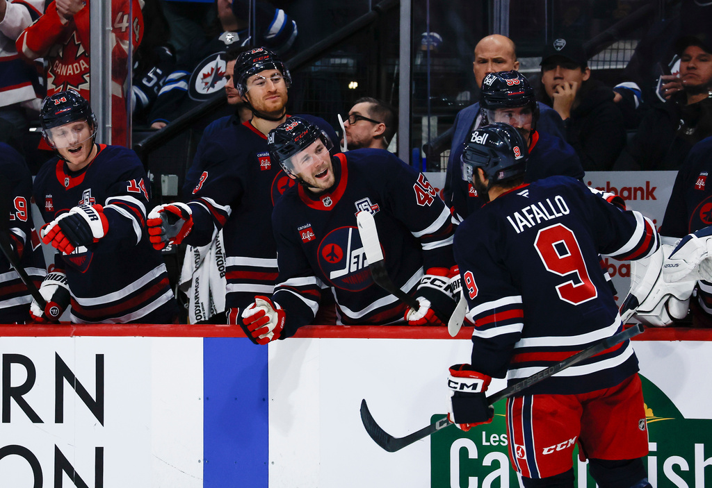 Winnipeg Jets' Alex Iafallo (9) celebrates his goal against the Washington Capitals during the second period of an NHL game in Winnipeg on Saturday, Dec. 13, 2025. (John Woods/The Canadian Press via AP)
