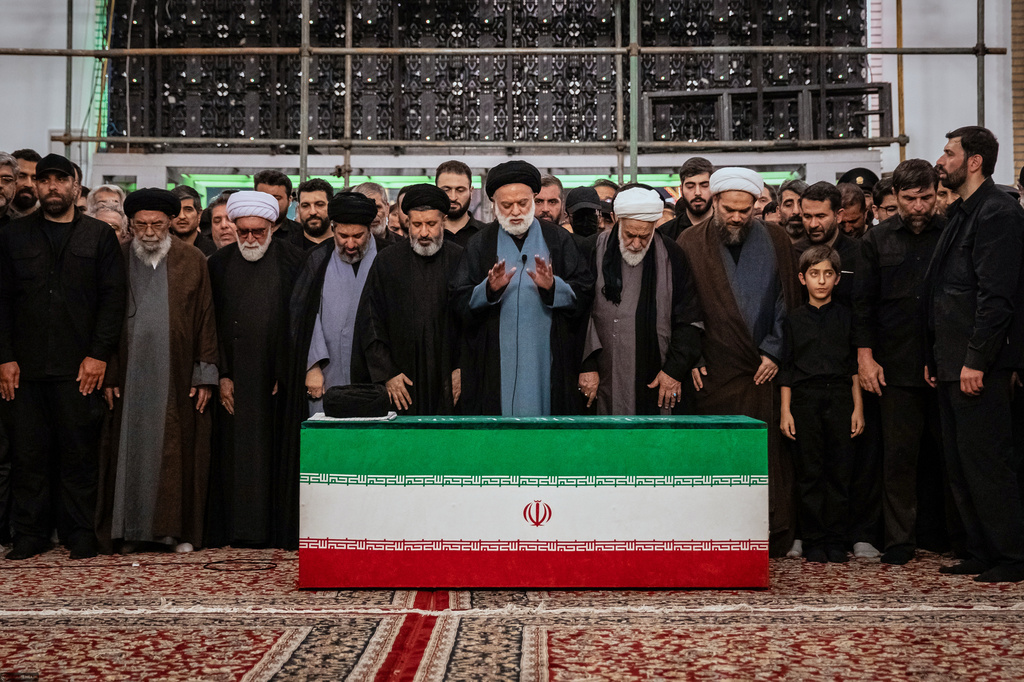 Mostafa Khamenei, center, brother of Iran's new Supreme Leader Mojtaba Khamenei, leads a prayer over the coffin of his late father, Iranian Supreme Leader Ayatollah Ali Khamenei before his burial at the Imam Reza Shrine in Mashhad, northeastern Iran, Thursday, July 9, 2026. (Office of the Iranian Supreme Leader via AP)
