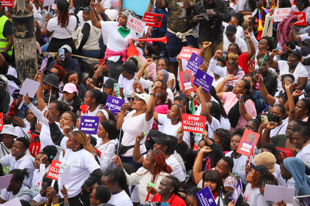 Demonstrators hold placards, during a march against rising cases of femicide, in downtown Nairobi, Kenya, Monday, June 1, 2026. (AP Photo/Patrick Ngugi)
